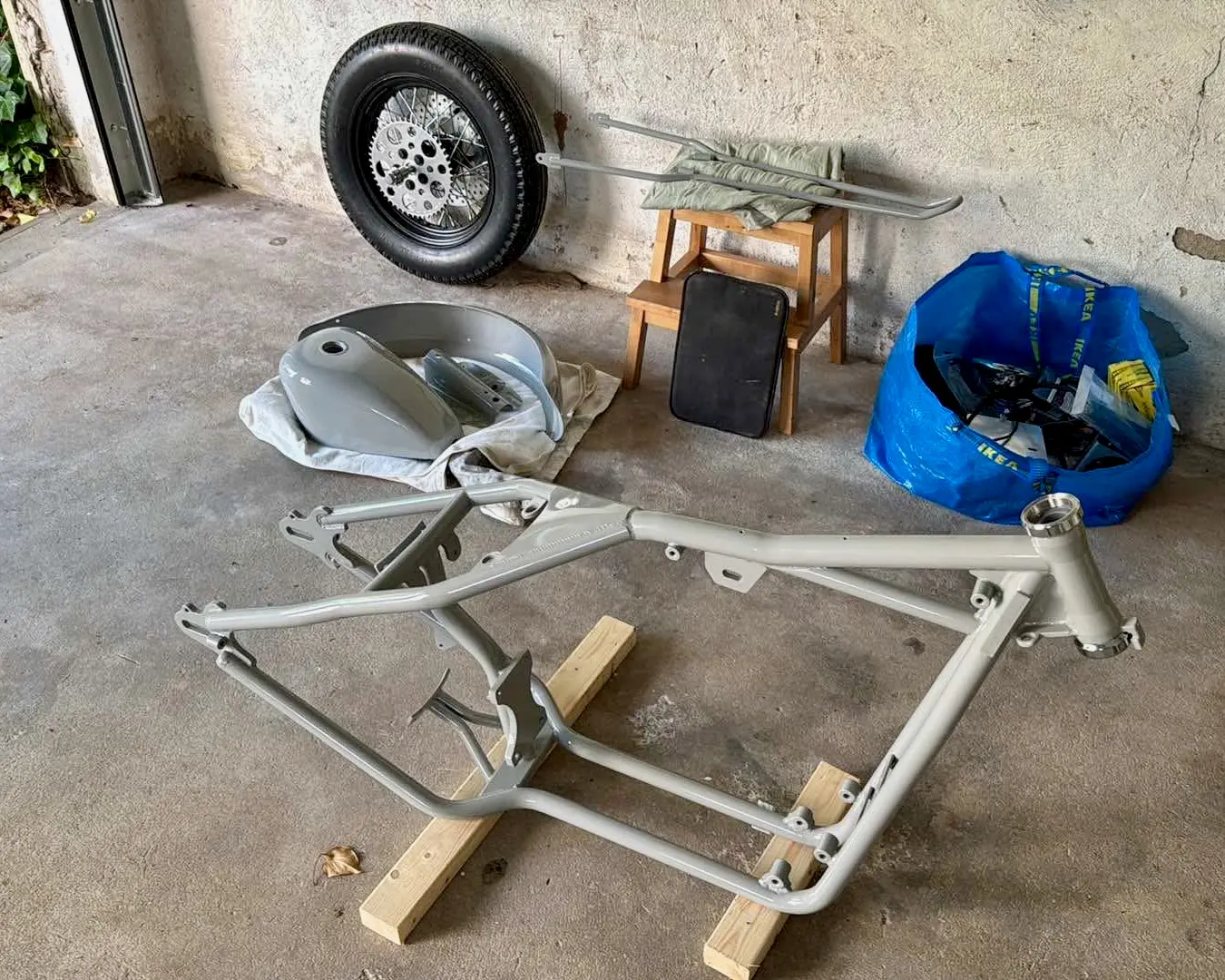 The frame stripped bare on the garage floor, every part removed