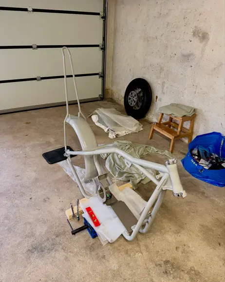 The bare frame propped up in the garage, ready to go away