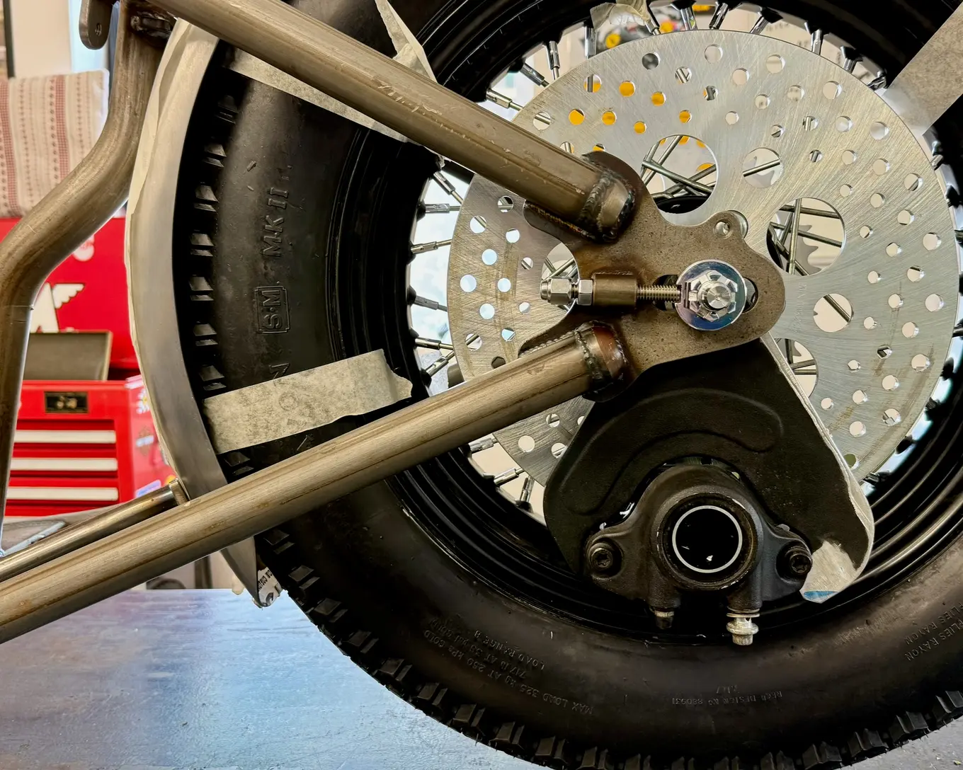 The rear caliper bolted to its mount beside the disc