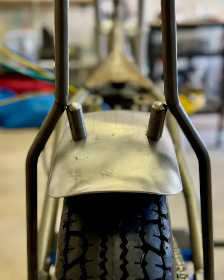 The rear fender shaped over the tire, seen from behind