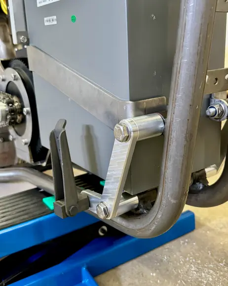 A floorboard bracket hung off the frame rail