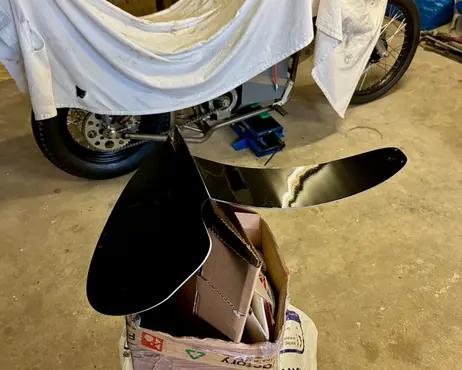The seat, covered in black leather, packed in a box
