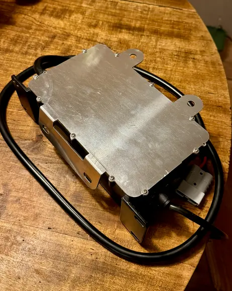 The battery box opened, showing the pack and its plate inside
