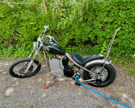 The bike outside on the gravel, seen from the side