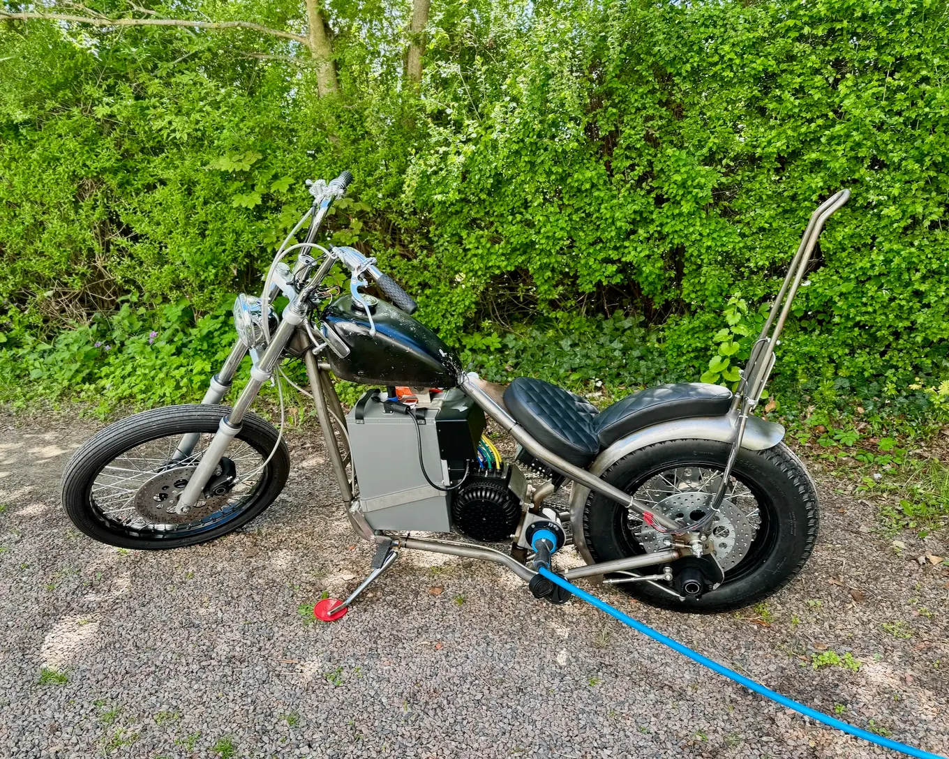 The bike outside on the gravel, seen from the side