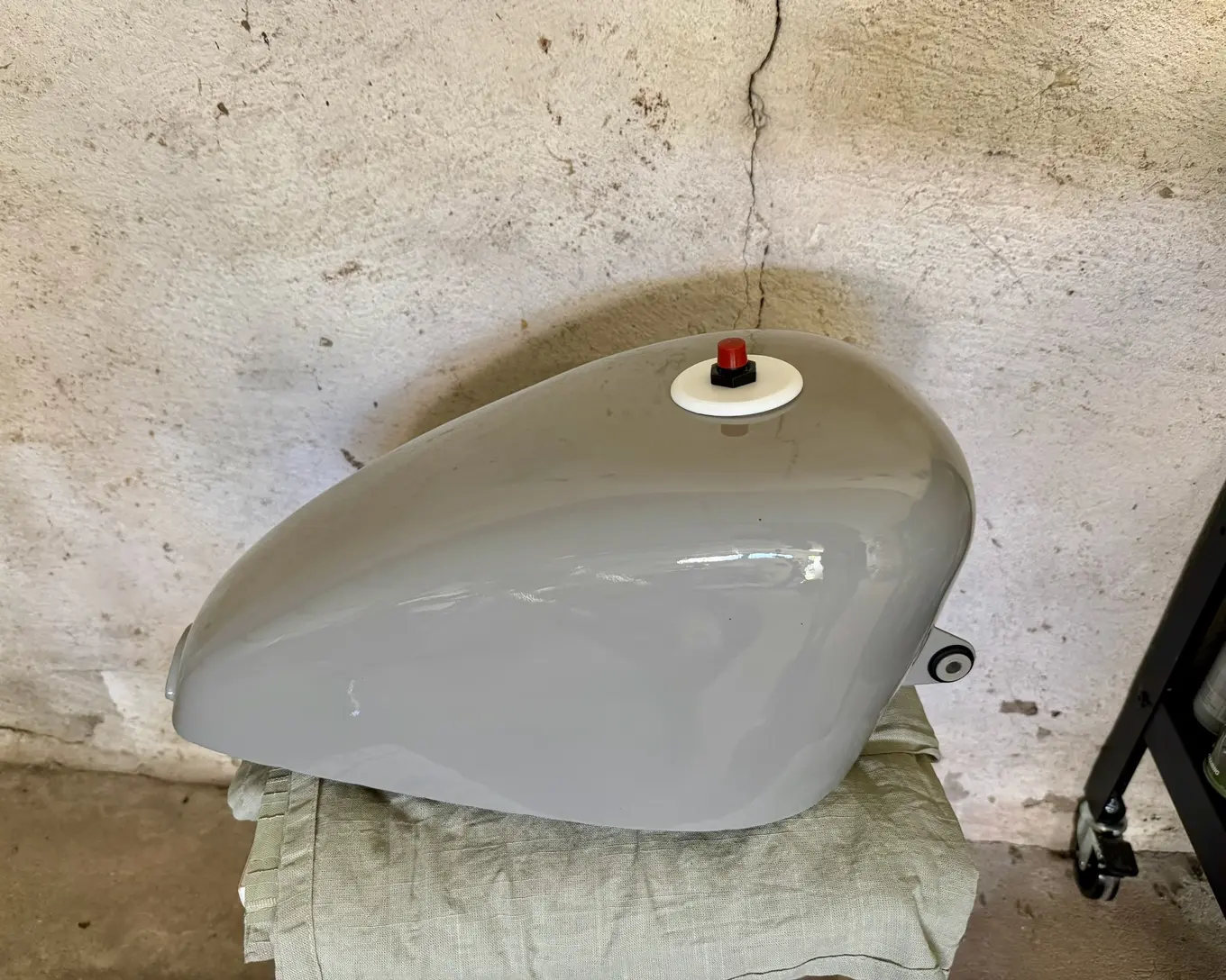 The painted tank on a blanket, its filler cap fitted