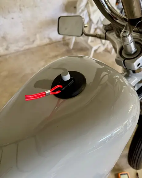 The filler opening on the tank with the charge lead coming out of it