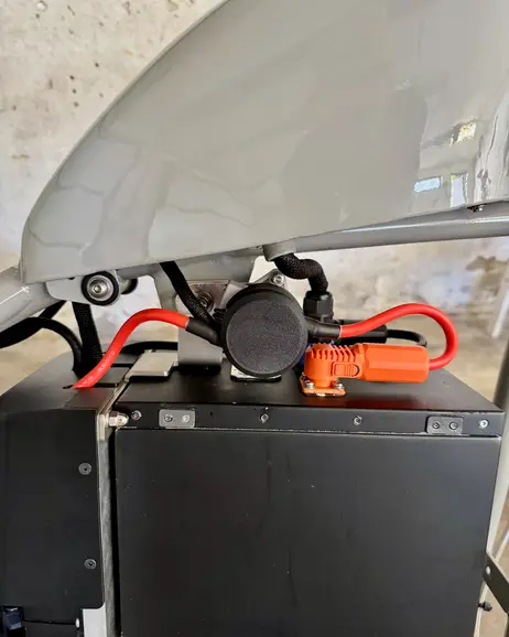 The charge port cap fitted in the tank, seen from the side