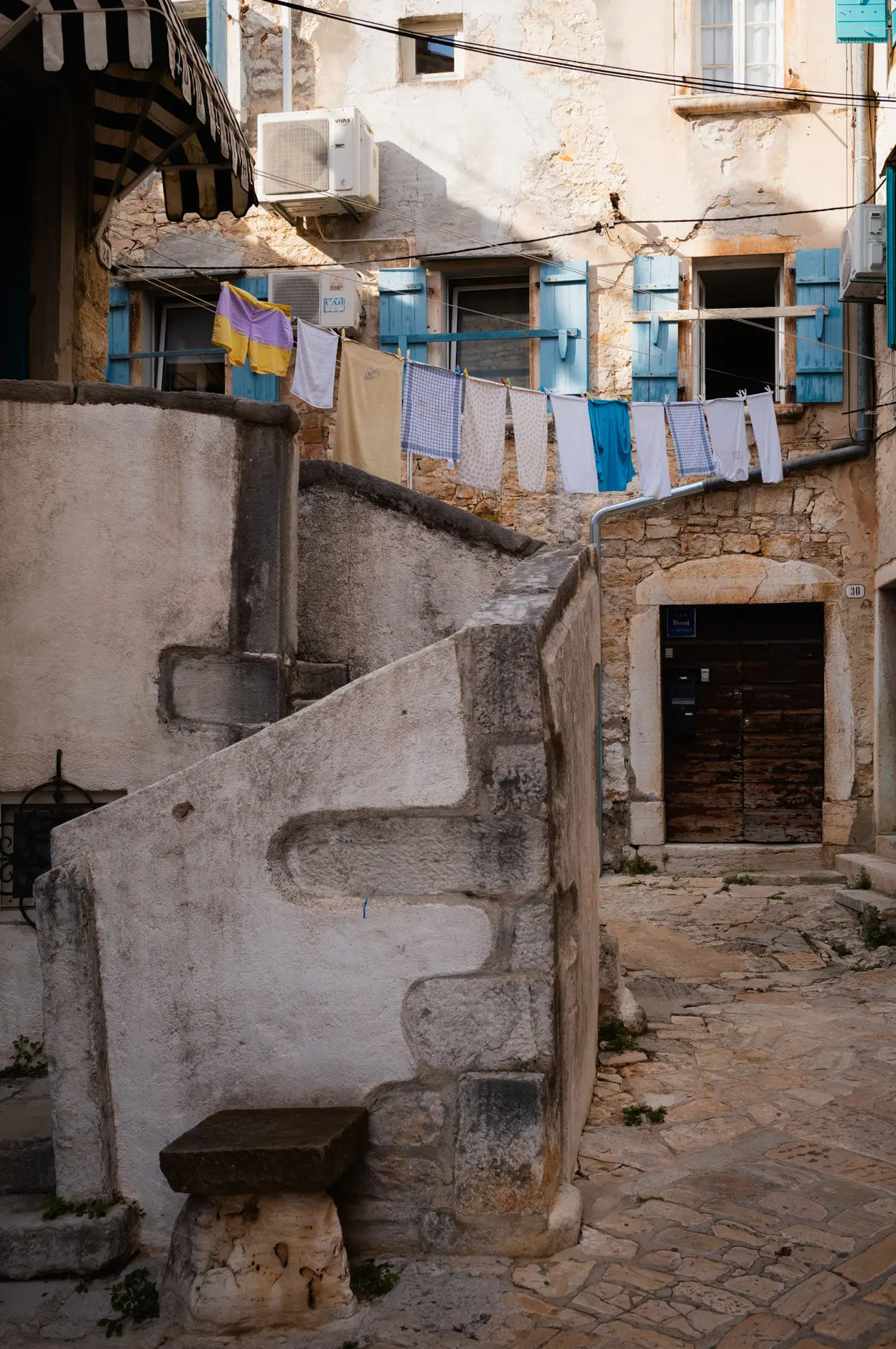 Washing strung above a stone stair in the old town